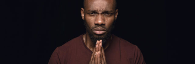 A man holding his hands in prayer