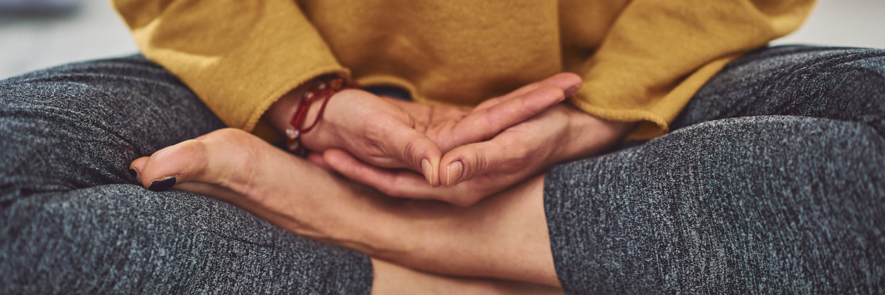 Tips for Doing Yoga After a Brain Injury Woman meditating or doing yoga.