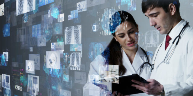 Medical researchers looking at data on tablet.