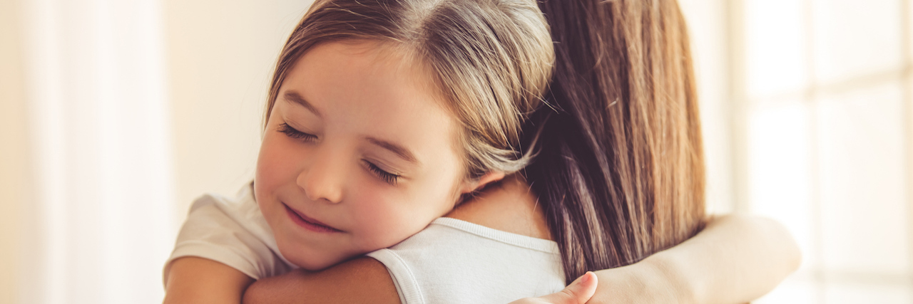 Supporting My Child Through Her Fight With OCD and Anxiety Mother and daughter hugging at home