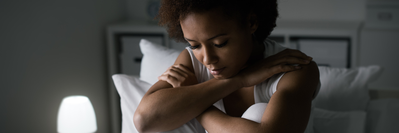 Study: Hospitalized COVID-19 Patients at Risk for PTSD Sad depressed woman sitting in her bed late at night