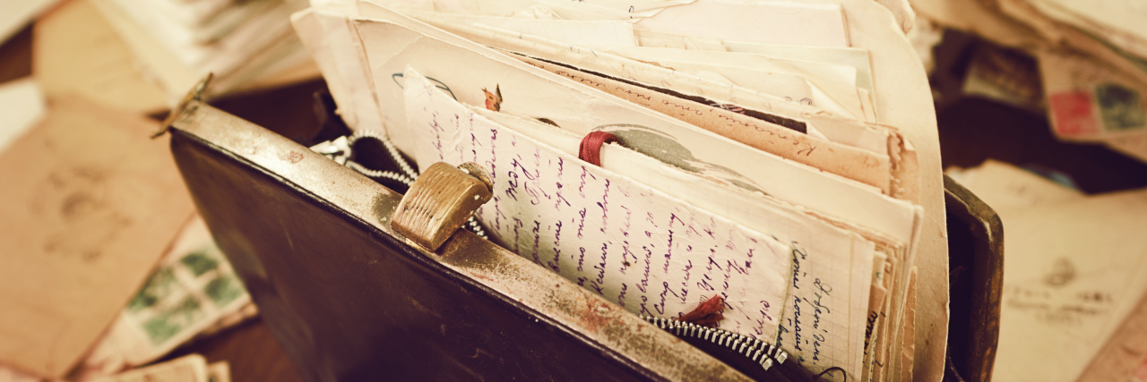 What My Mom With Alzheimer's Purse Taught Me About Missing Someone Old papers in a vintage handbag