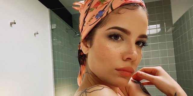 Halsey Calls out People Making Jokes About Bipolar Disorder Halsey, standing in a bathroom wearing a pink-colored headband
