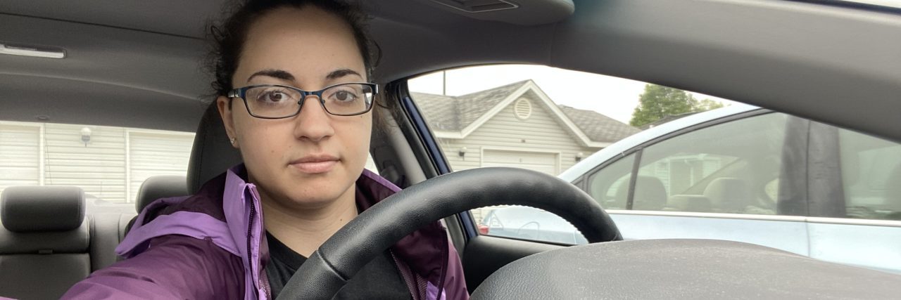The author behind the wheel of her car