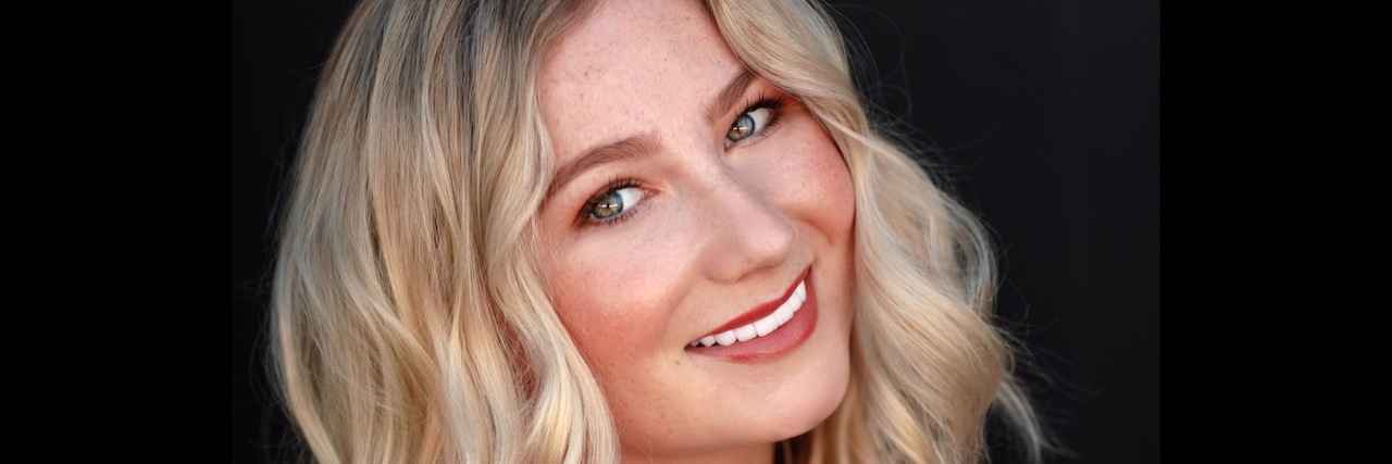 Keely Cat-Wells Launches New Accessible Entertainment Studio Keely Cat-Wells headshot, a woman with long, wavy blonde hair wearing a ruffled orange top