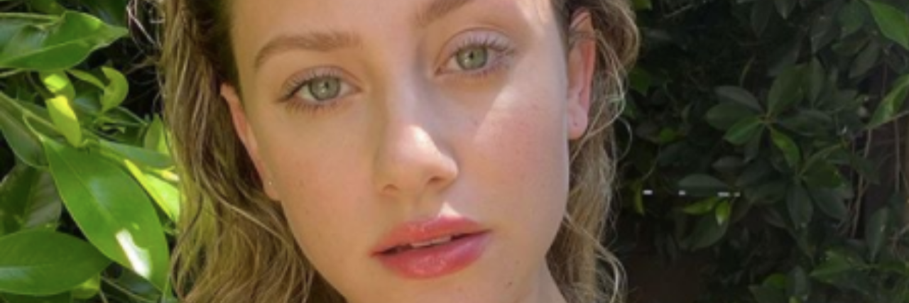 ‘Riverdale’ Actress Lili Reinhart on COVID-19 Mental Health Impact Lili Reinhart, a woman with long blonde hair, wearing a neon green biki top
