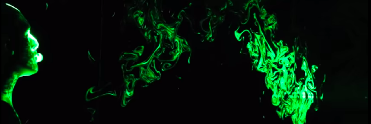 Study Visually Shows Effectiveness of Face Coverings for COVID-19 Mannequin head on black screen with green smoke floating across the background