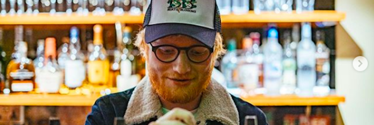 Ed Sheeran Shares Emotions Behind Having an ‘Addictive Personality' Ed Sheeran wearing a ball cap standing at the counter of a bar