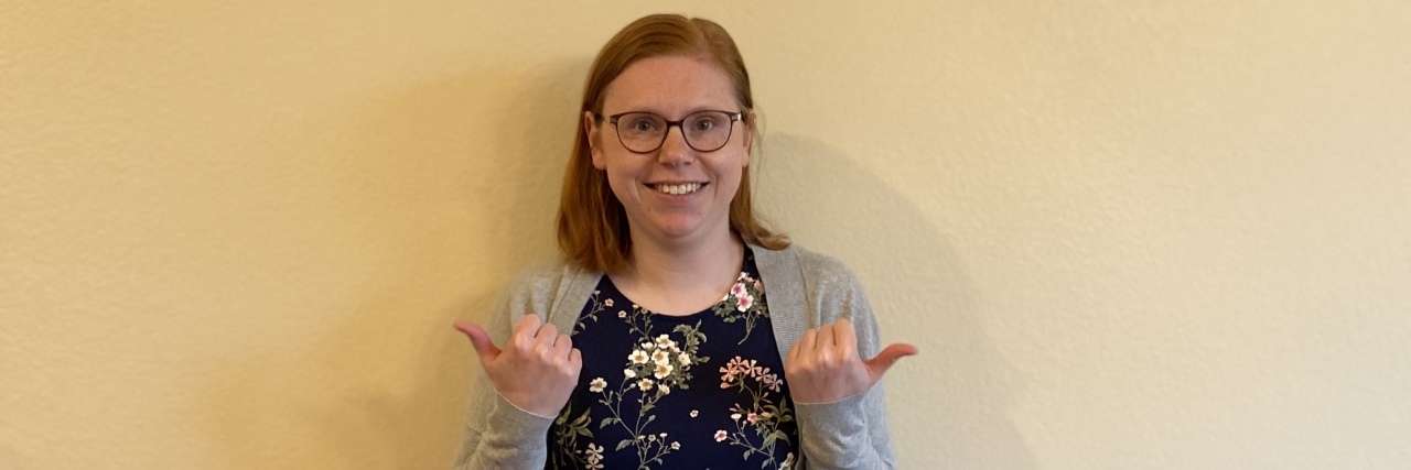 What Disability Pride Means to Me Becca giving thumbs up.