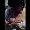 A mom cradling her newborn baby in the intensive care unit