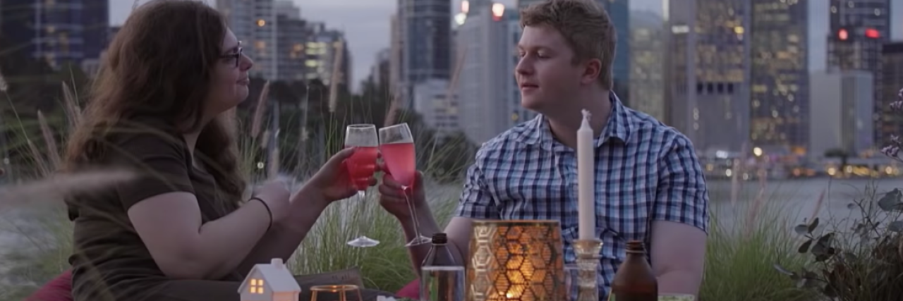 An Autistic Man Reviews 'Love on the Spectrum' on Netflix Two people on a date, with a city in the background