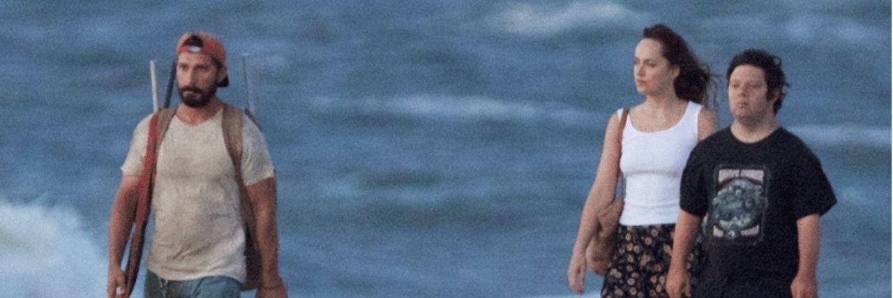 15 Reasons Why You Need to Watch 'The Peanut Butter Falcon' three people are walking in the water