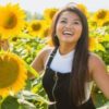 photo of smiling or laughing woman in a field of sunflowers
