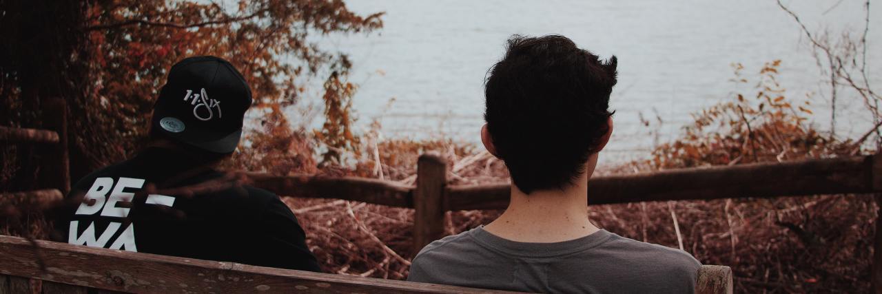 Borderline Personality Disorder and Helping Other People in Crisis photo of two men sitting by lake and talking