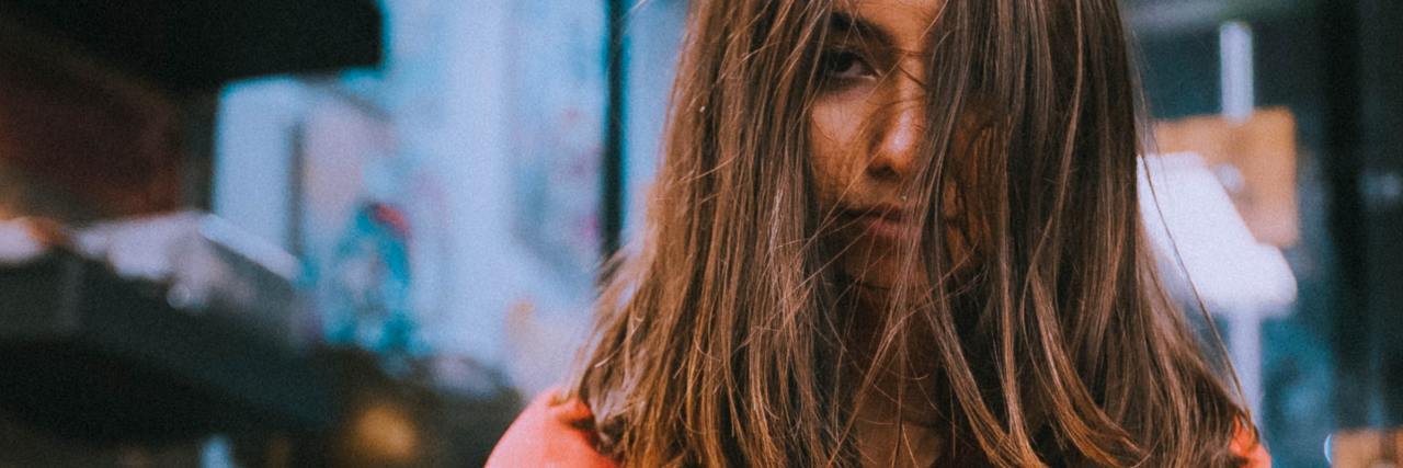 Mental Health Judgment From a Medical Professional in an Ambulance photo of unhappy looking woman with crossed arms, wearing a purple robe and looking into camera