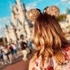 Woman wearing Disney ears at Disney World in front of the castle