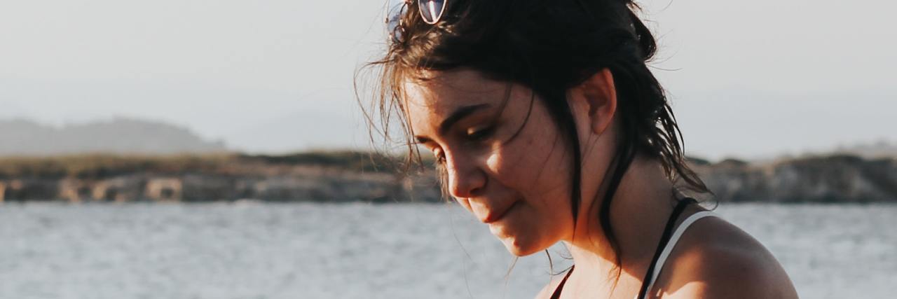 How To Handle COVID-19 as an Overthinker photo of woman by ocean looking worried or anxious