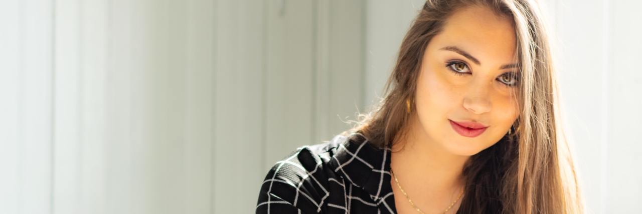 My Go-To Phrase for Asking for More Information as a Therapist photo of young professional latina woman looking into camera