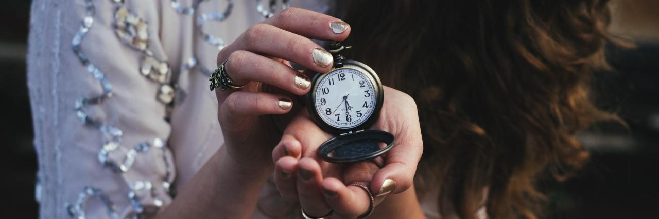 Time Blindness: Why ADHD Makes You Struggle With the Passage of Time close up photo of a woman holding an open pocket watch