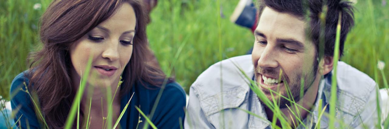 Grass is Greener Syndrome: Euphoric Memories and Craving photo of couple lying in field of long grass