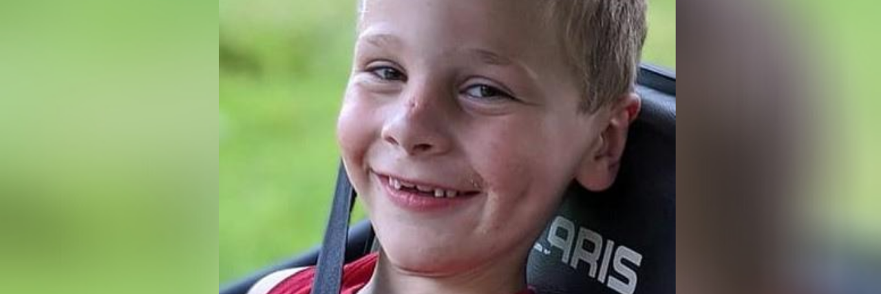 Wearing a Mask Isn't a 'Personal Decision,' It Protects Others Teddy, a young boy with blonde hair sitting in a car.