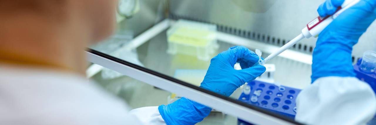 The Industry Response to COVID-19 Is a Blueprint for Accelerating Rare Disease Treatments A scientist injecting something into a test tube