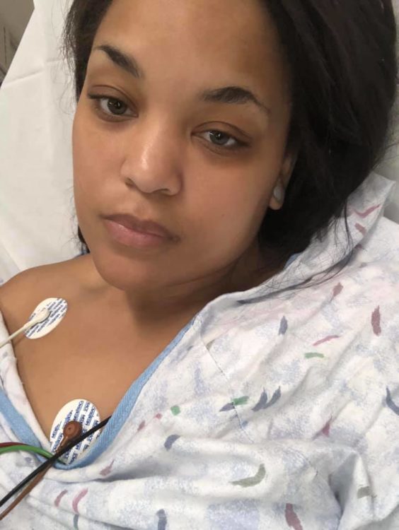 A selfie of a woman in a hospital bed