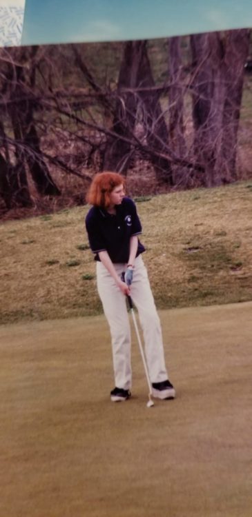 A teenage girl golfing