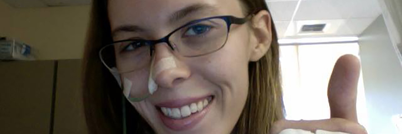 Living With Celiac Disease in Your 20s Casey in the hospital with an NG tube giving a thumbs up.