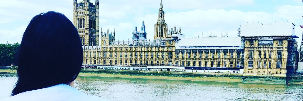 I’m 'Sick' of Unsolicited Advice About How to Cure My Chronic Illness Georgia standing by a wall looking out over a river.