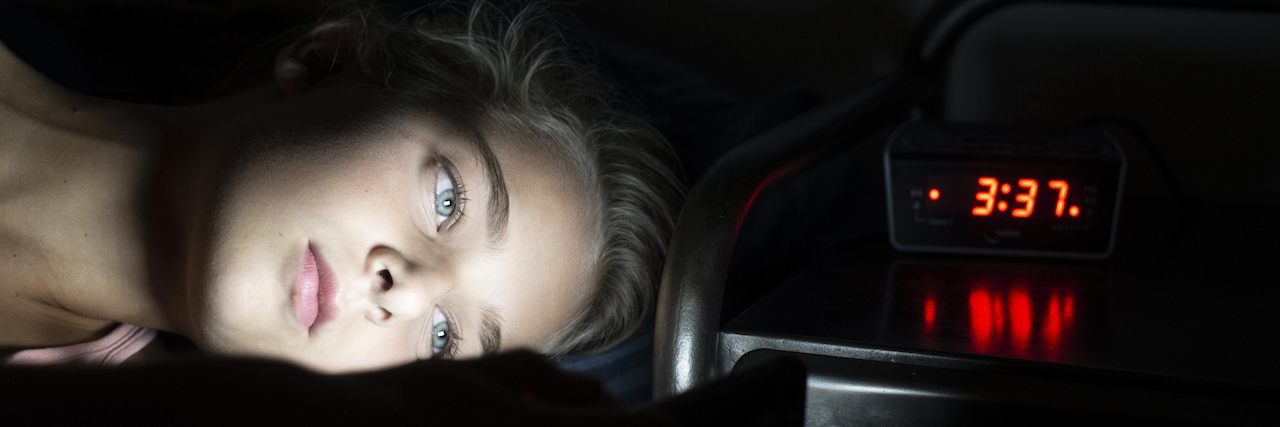 To the Student Who Has to Go to School Virtually in an Unsafe Home Young teenage girl in bed late at night using her smartphone.