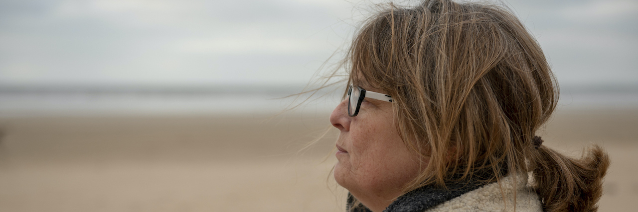 The Importance of Acknowledging That My Mental Illness Is Real Woman at the beach in winter