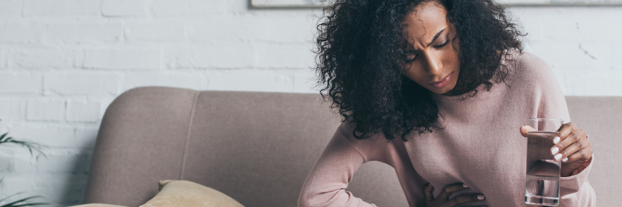 8 'Habits' of People With Gastroparesis A woman holding her stomach