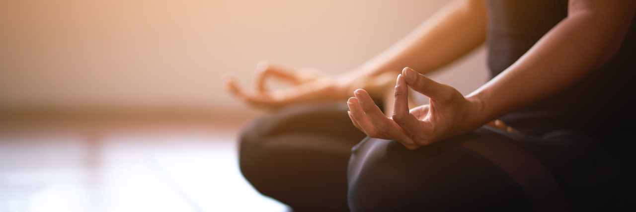 Addressing Ableism in Yoga Women in meditation while practicing yoga.
