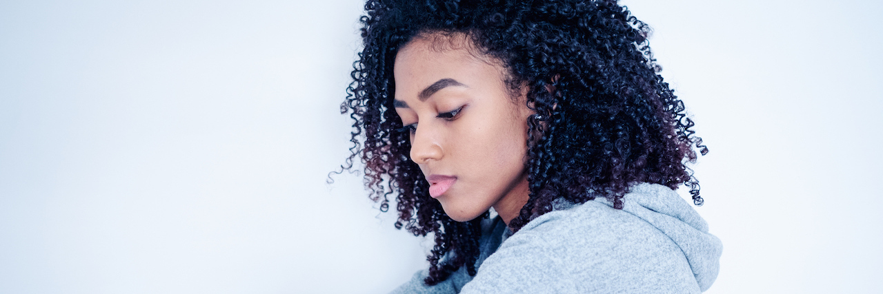 Depressed black young girl isolated on white background