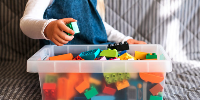 5 Things You Should Know About Acid Sphingomyelinase Deficiency  Little girl cleaning up the toy box at home.