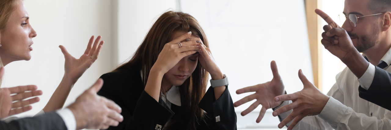 How Distractions Affect Me as Someone With a Brain Injury Frustrated woman caught in the middle of conversations.