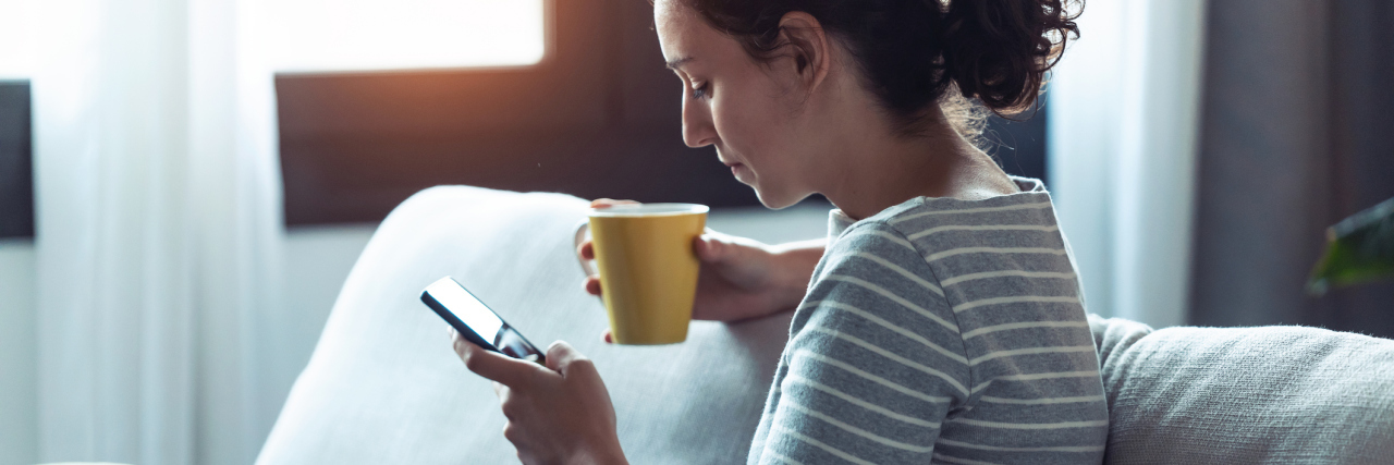 What To Do When Your Therapist Upsets You photo of woman with a mug and holding her phone with a serious expression