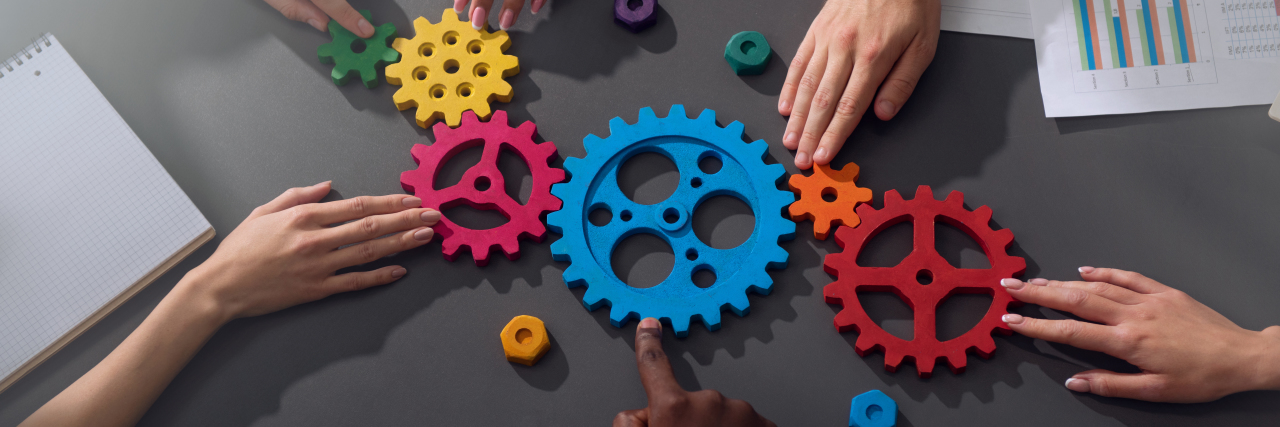 Struggling With 'Teamwork' as Someone on the Autism Spectrum Teamwork metaphor of business people working together.