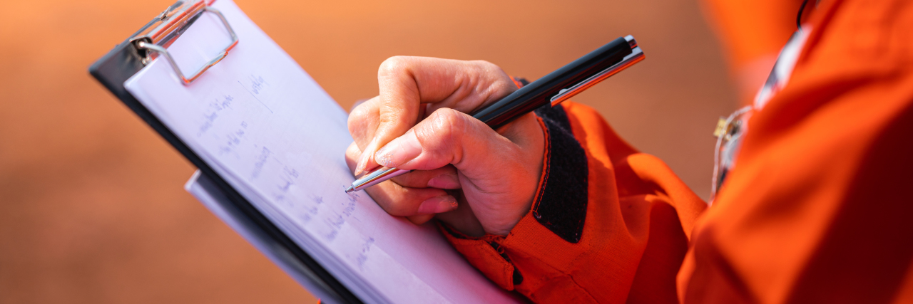 Woman writing note on paper.