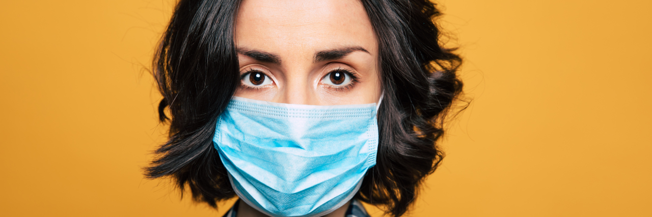 Wear a Mask to Protect People Like Me During COVID-19 Woman wearing disposable face mask.