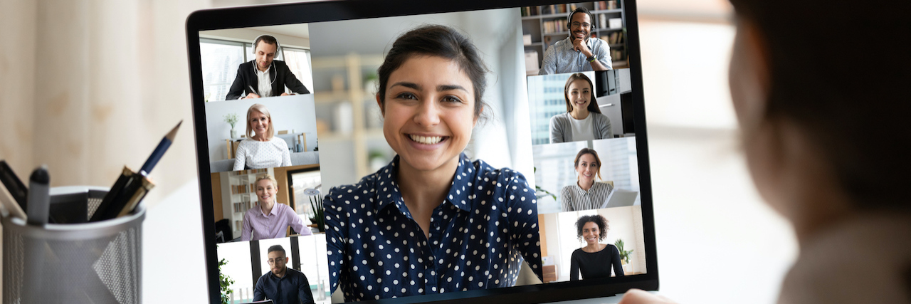 What I Learned at the International OCD Foundation Virtual Conference Woman at desk looking at computer screen with a collage of diverse people