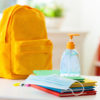 Backpack of school child with face mask and sanitizer