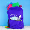 Backpack full of school supplies and COVID 19 prevention supplies.