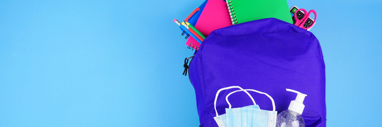Backpack full of school supplies and COVID 19 prevention supplies.