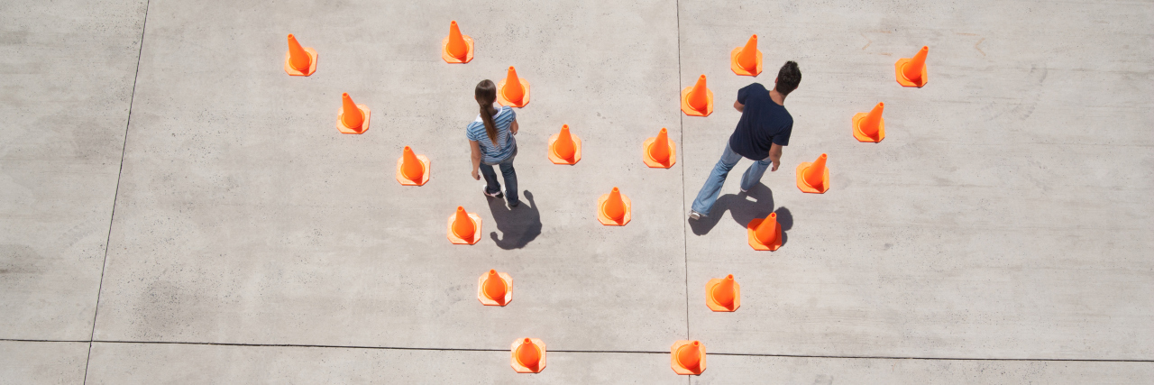 Why Losing Friends Is Sometimes Necessary in Life With a Disability Man and woman in traffic cones moving apart