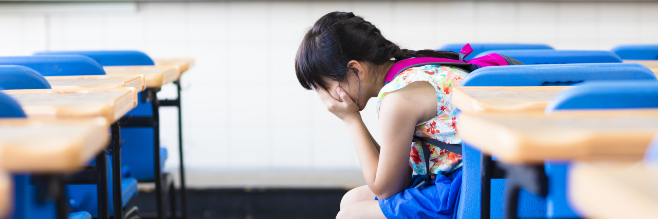 Being Mistreated by Teachers as Someone With Learning Disabilities Sad girl crying in the classroom.