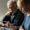 photo of older couple making a decision on something with a laptop