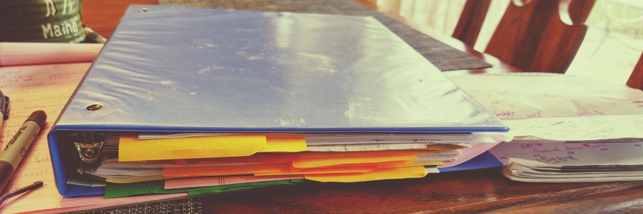 Supporting a Child With Bipolar Disorder and Autism Binder filled with educational and medical records.