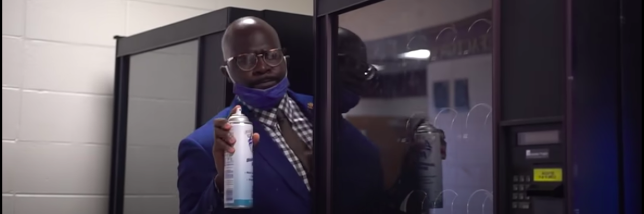Alabama Principal's COVID-19 'Can't Touch This' Video Goes Viral Dr. Quentin J. Lee peeks out from behind a school vending machine ready to spray a can of Lysol